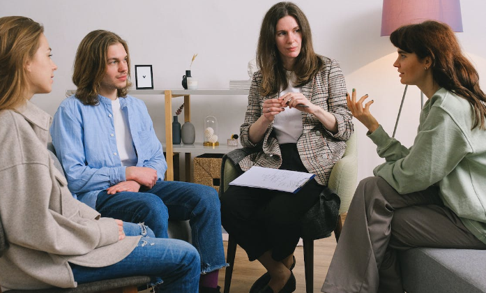 A group of people in a therapy session as a system treatment for addiction